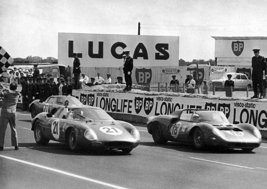 The Ferrari (No. 21) of Masten Gregory, of USA, and Jochen Rindt, of Austria, crosses the finish line to win the grueling, 24-hour Le Mans automobile race in Le Mans, France on June 20, 1965. The Ferr ...