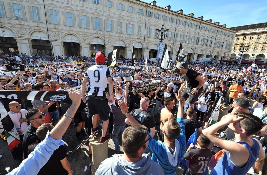Juventus fans celebrate as their team won an unprecedented sixth consecutive Italian title, at the end of the Serie A soccer match between Juventus and Crotone, at San Carlo&#039;s square in Turin, It ...