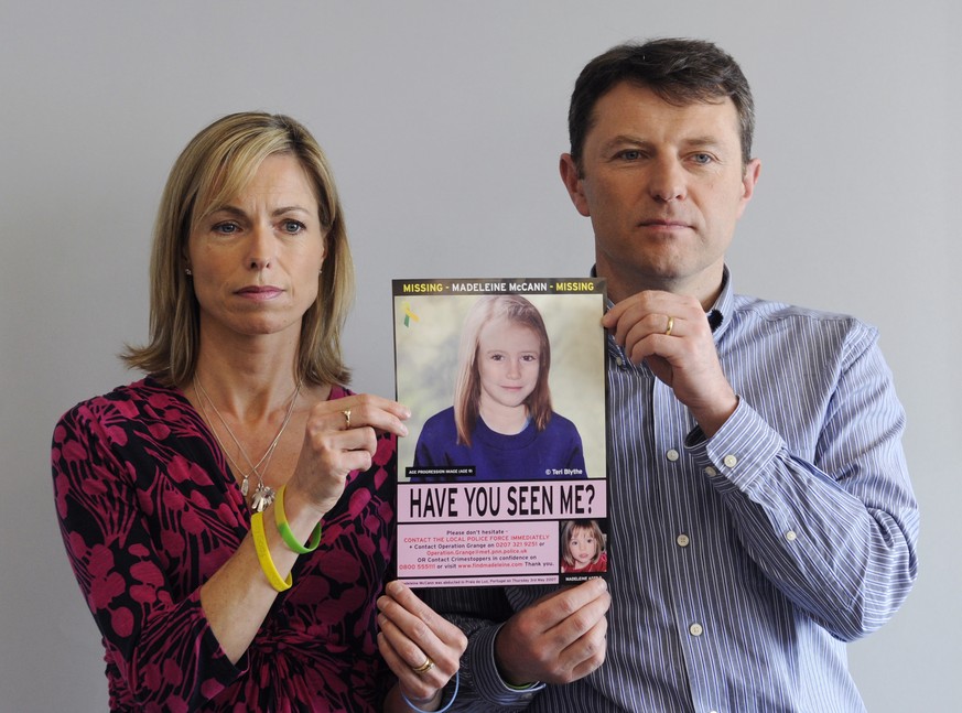 epa08463355 (FILE) - A file photograph dated 02 May 2012 shows Kate (L) and Gerry McCann (R) holding an age-progressed police image of their daughter Madeleine during a news conference to mark the 5th ...