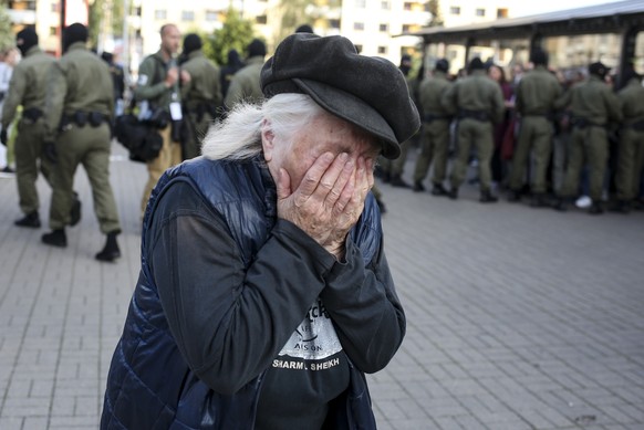An elderly woman reacts as police officers detain women during an opposition rally to protest the official presidential election results in Minsk, Belarus, Saturday, Sept. 19, 2020. Daily protests cal ...