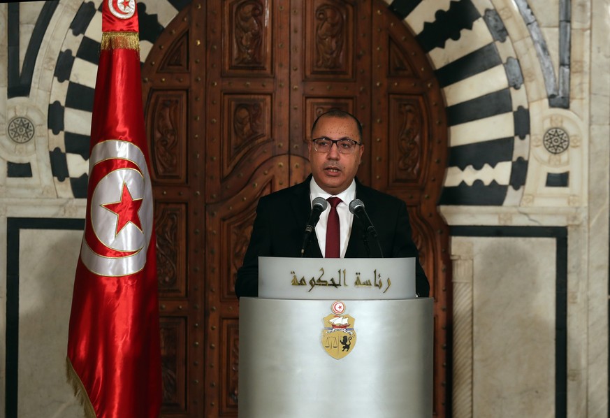 epa09365584 (FILE) - Tunisian Prime Minister Hichem Mechichi speaks to the media during a press conference to announce a cabinet reshuffle in Tunis, Tunisia, 16 Janury 2021 (Reissued 25 July 2021). On ...