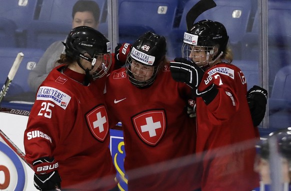 Switzerland forwards Alina Muller (25), Rahel Enzler (28) and Lara Stalder celebrate after Muller&#039;s goal during the first period of a IIHF Women&#039;s World Championship hockey tournament game a ...