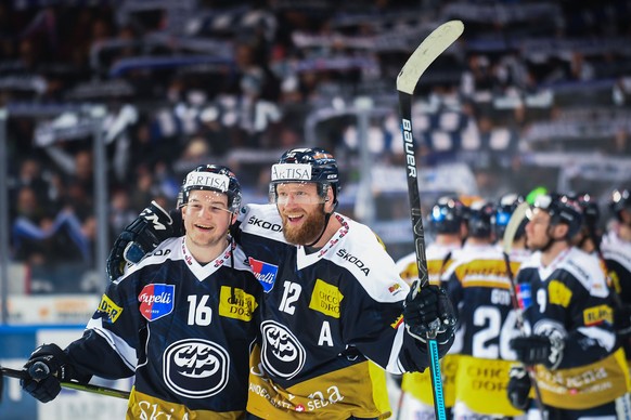 Ambri&#039;s player Dominic Zwerger, left, and Ambri&#039;s player Jiri Novotny celebrate the victory, after the preliminary round game of National League Swiss Championship 2018/19 between HC Ambri P ...