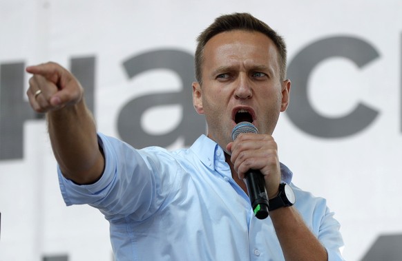 FILE - In this Saturday, July 20, 2019 file photo Russian opposition activist Alexei Navalny gestures while speaking to a crowd during a political protest in Moscow, Russia. Russian opposition leader  ...