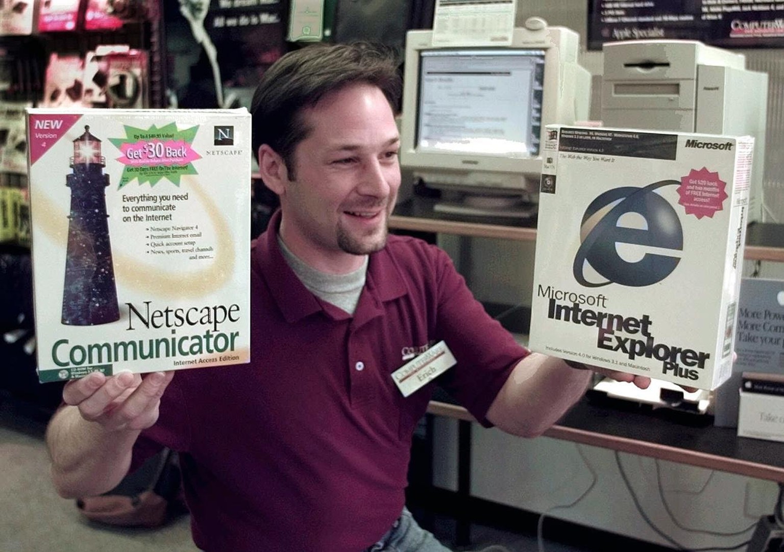 Computerware assistant manager Erich Geist holds up internet browsers Netscape Communicator,left, and Microsoft Internet Explorer, right, at the Apple computer store in Sunnyvale, Calif., Monday, May  ...