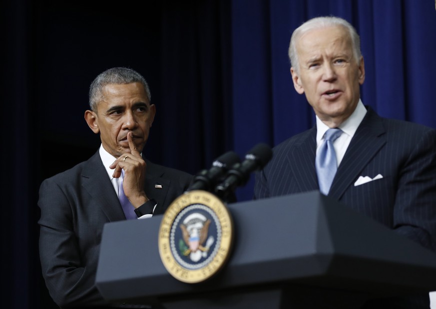 FILE - In this Dec. 13, 2016, file photo, President Barack Obama listens as Vice President Joe Biden speaks in the South Court Auditorium in the Eisenhower Executive Office Building on the White House ...