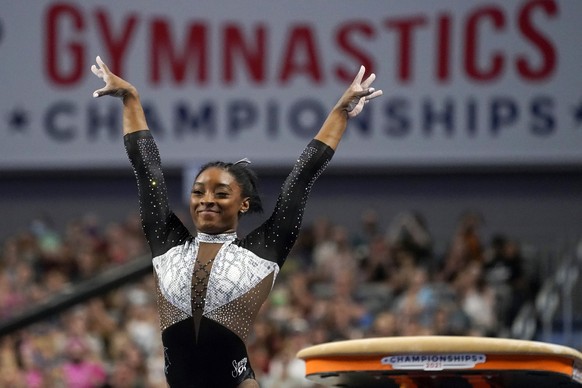 FILE - In this Sunday, June 6, 2021 file photo, Simone Biles celebrates after competing in the vault during the U.S. Gymnastics Championships in Fort Worth, Texas. Private, touching moment between lov ...