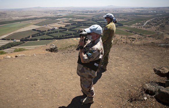 epa08675020 UNDOF (United Nations Disengagement Observer Force) soldiers monitor the area at Ben Tal overlooking the Israeli-Syrian border, 17 August 2020 (issued 17 September 2020). The United Nation ...