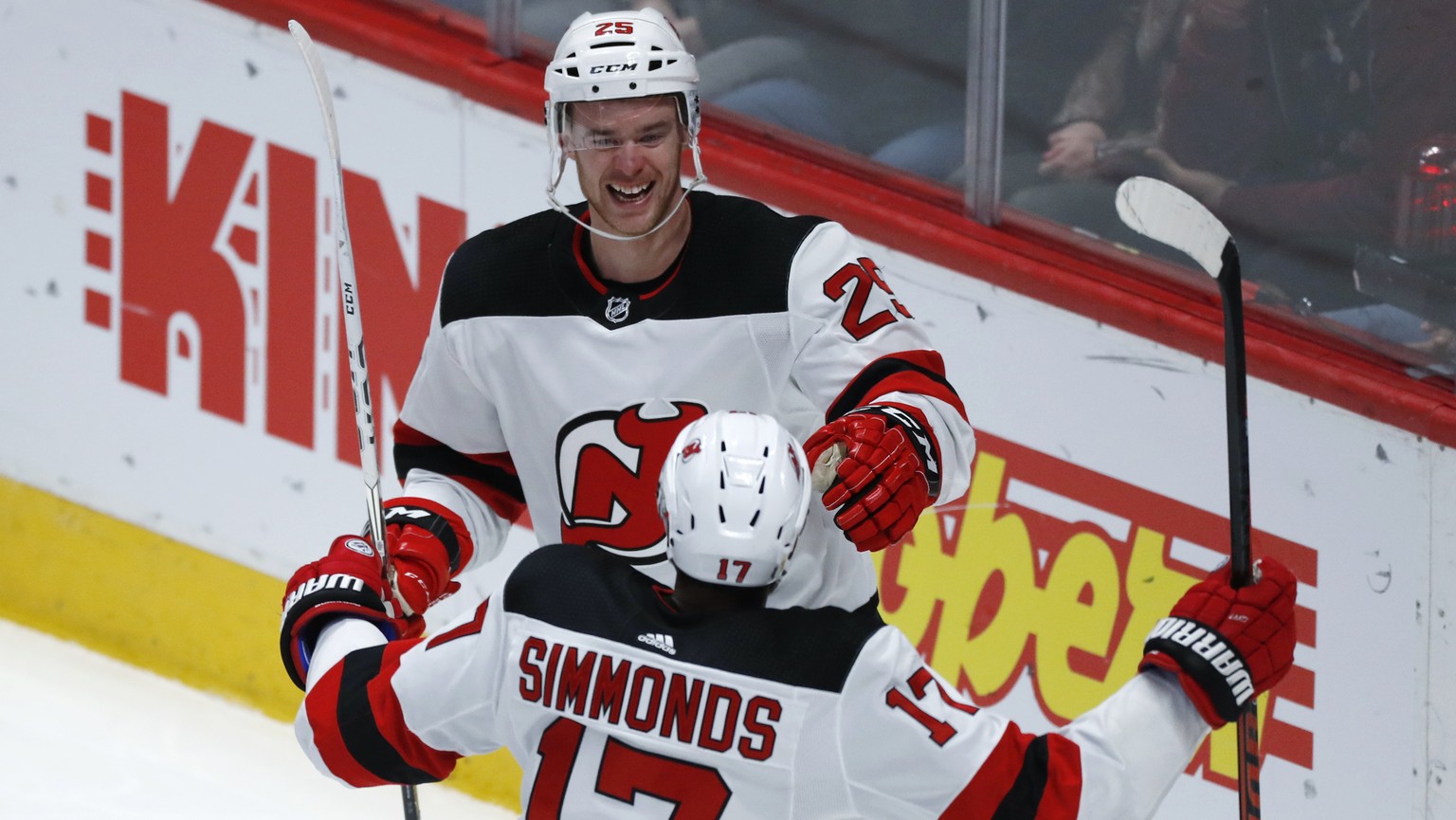New Jersey Devils defenseman Mirco Mueller, back, celebrates scoring a goal with right wing Wayne Simmonds in the third period of an NHL hockey game against the Colorado Avalanche Friday, Dec. 13, 201 ...