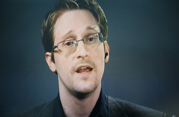 epa08792820 (FILE) - Edward Snowden, seen on a screen via satellite from Moscow, Russia, speaks during a press conference about a new campaign to persuade US President Barack Obama to pardon him for v ...
