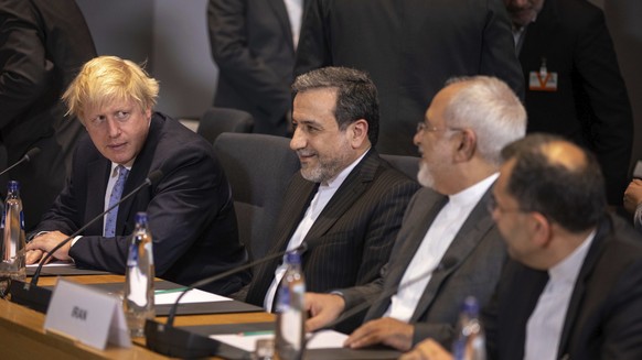 British Foreign Secretary Boris Johnson, looks at Iranian Foreign Minister Javad Zarif, second right, during a meeting of the foreign ministers from Britain, France and Germany with the Iran Foreign M ...