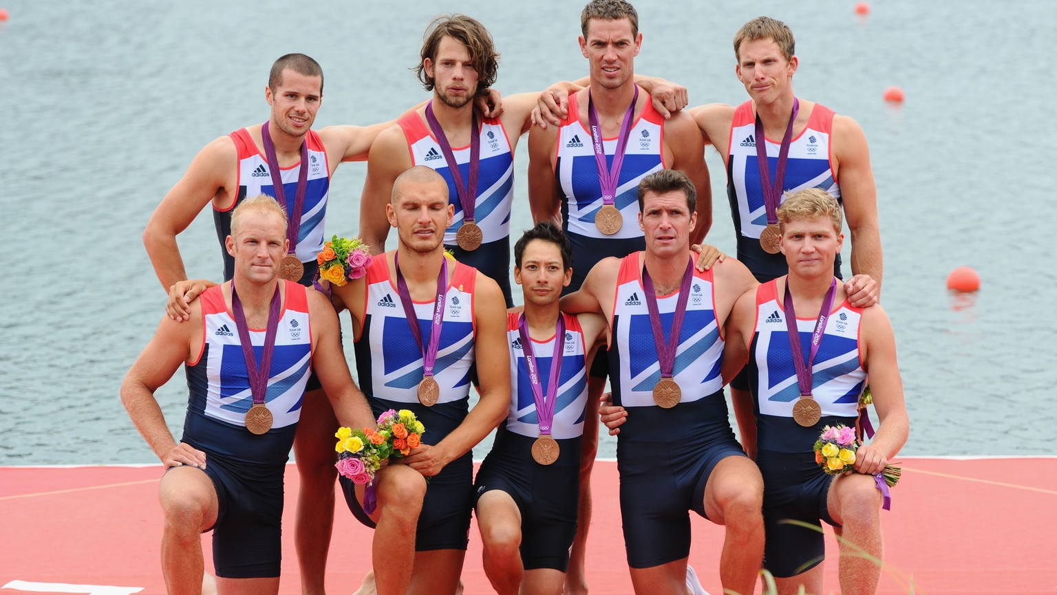 WINDSOR, ENGLAND - AUGUST 01: The Great Britain team members celebrate with their medals after winning bronze in the Men&#039;s Eight Final on Day 5 of the London 2012 Olympic Games at Eton Dorney on  ...