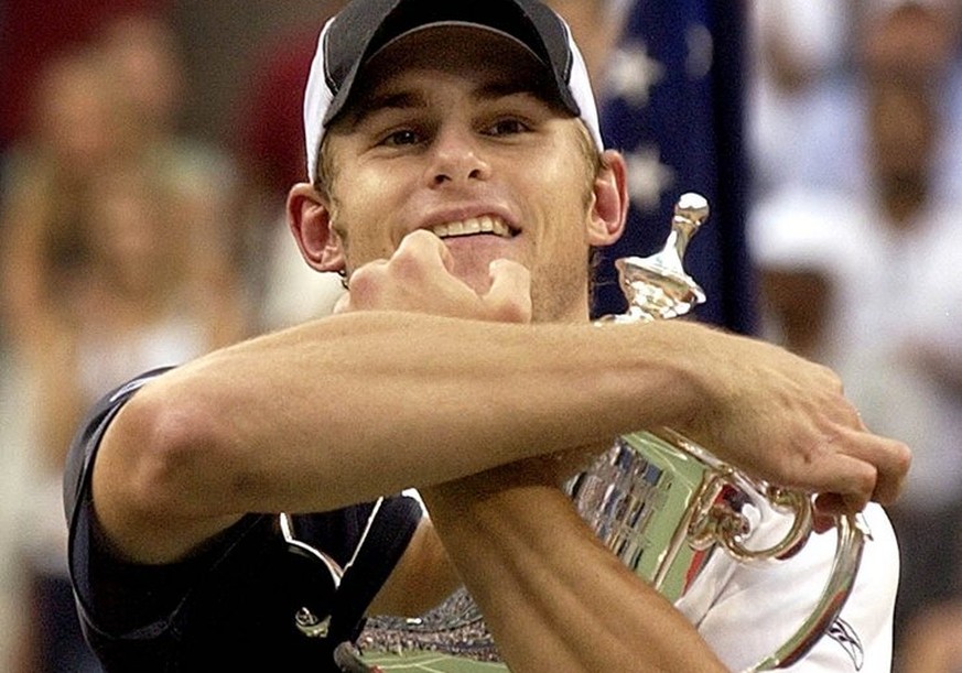 Andy Roddick of the US hugs the US Open trophy after defeating Juan Carlos Ferrero of Spain in the men&#039;s final Sunday 07 September, 2003 at the US Open in Flushing Meadows, NY. EPA PHOTO/EPA/Rhon ...