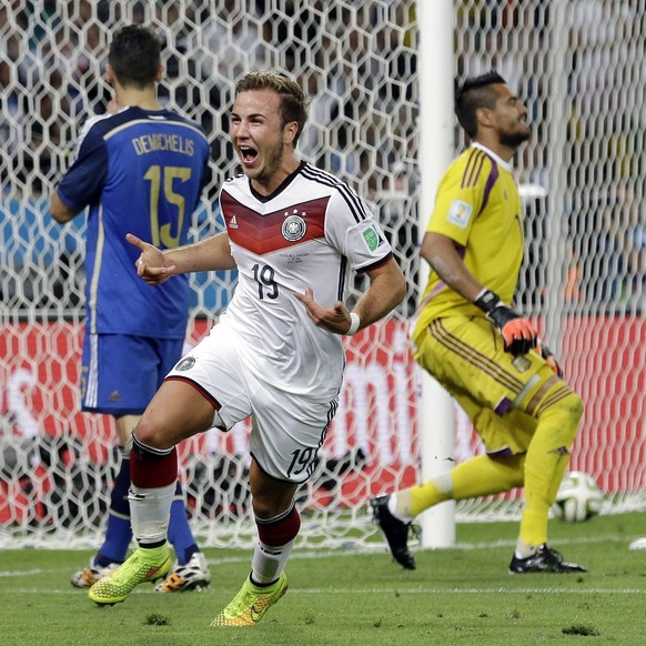 FILE - In this July 13, 2014 file photo, Germany&#039;s Mario Goetze celebrates after scoring the opening goal past Argentina&#039;s goalkeeper Sergio Romero during the World Cup final soccer match be ...