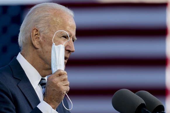 Democratic presidential candidate former Vice President Joe Biden holds up his mask as he speaks at Gettysburg National Military Park in Gettysburg, Pa., Tuesday, Oct. 6, 2020. (AP Photo/Andrew Harnik ...