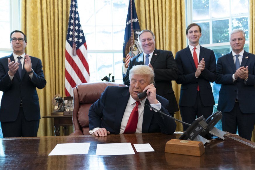FILE - In this Oct. 23, 2020 file photo, President Donald Trump talks on a phone call with the leaders of Sudan and Israel, as Treasury Secretary Steven Mnuchin, left, Secretary of State Mike Pompeo,  ...