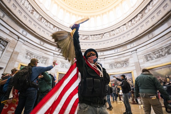 epa08926300 Supporters of US President Donald J. Trump and his baseless claims of voter fraud run through the Rotunda of the US Capitol after breaching Capitol security during their protest against Co ...