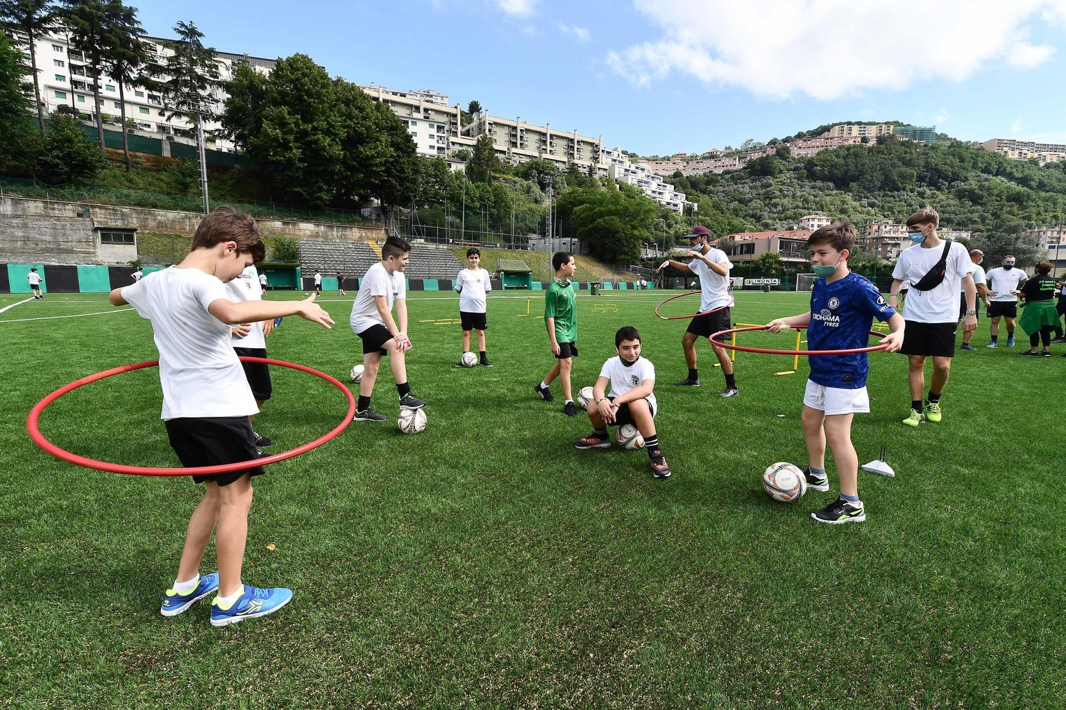 epa08486851 Youngsters warm up during the soccer summer camp of the sports club USD Baiardo, in Genoa, Italy, 15 June 2020. The summer camp has opened in accordance with the rules of hygiene and socia ...