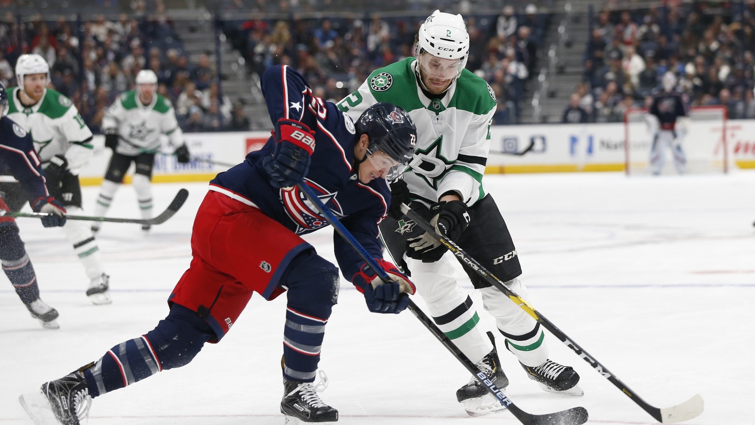 Dallas Stars&#039; Jamie Oleksiak, right, and Columbus Blue Jackets&#039; Sonny Milano vie for the puck during the second period of an NHL hockey game Wednesday, Oct. 16, 2019, in Columbus, Ohio. (AP  ...