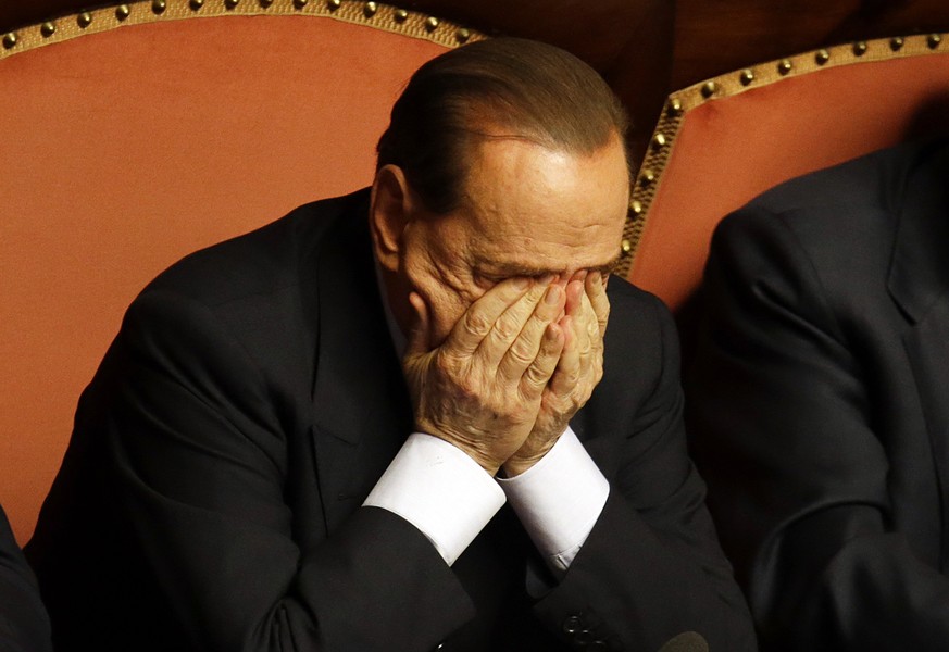 FILE - In this Wednesday, Oct. 2, 2013 file photo People of Freedom party leader Silvio Berlusconi rubs his eyes after delivering his speech at the Senate, in Rome. Italy&#039;s highest court was hear ...