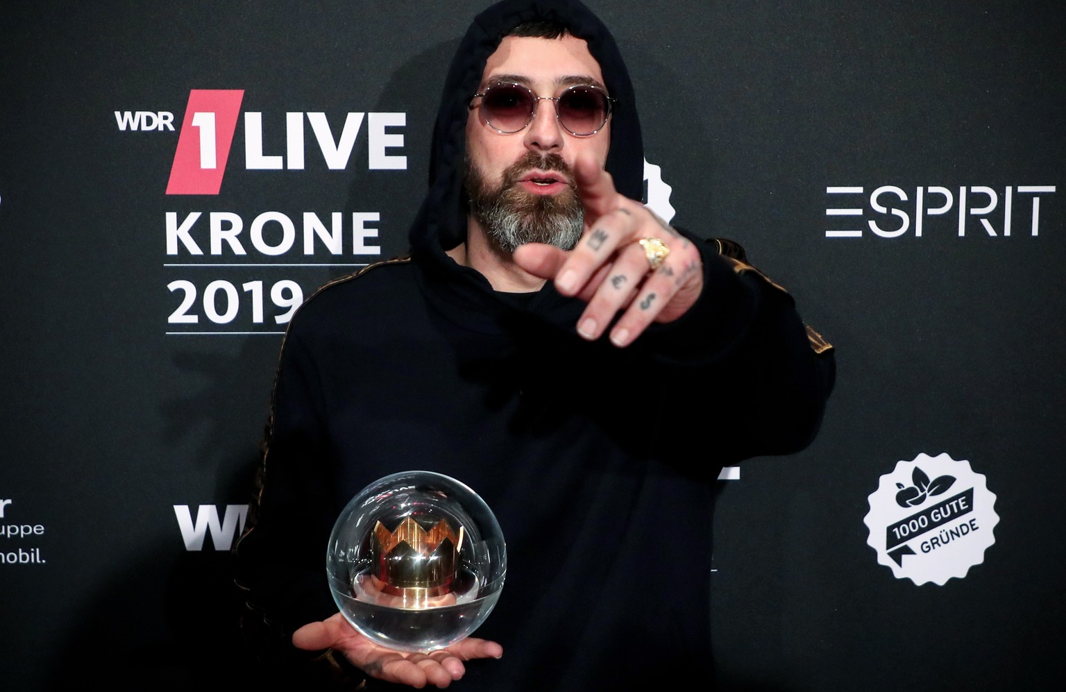 epa08047669 German rapper, actor and music producer SIDO poses with his trophy after the 20th 1LIVE Krone radio awards ceremony at the Jahrhunderthalle in Bochum, Germany, 05 December 2019. The radio  ...