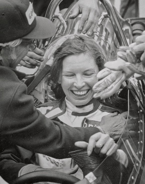 (Original Caption) Janet Guthrie is seen here as she receives congratulations from her car owner Rolla Vollstedt (L), as she completed her rookies test at the Indianapolis Motor Speedway. Ms. Guthrie, ...