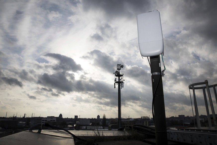 An antenna for the next 5G mobile internet standard is tested on a house in Hamburg, Germany, Thursday, Feb. 7, 2019. Germany want to sell frequencies for the next mobile generation by auction this ye ...