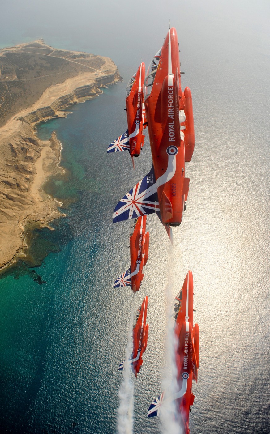 epa04228505 A handout photograph made available by the British Ministry of Defence showing Royal Air Force Aerobatic Team (RAFAT) The Red Arrows in flight after taking off from Royal Air Force (RAF) A ...
