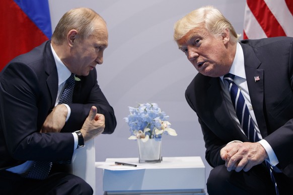 FILE - In this July 7, 2017, file photo, U.S. President Donald Trump meets with Russian President Vladimir Putin at the G-20 Summit in Hamburg. Putin won