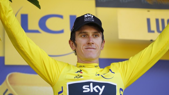 epa06908239 Team Sky rider Geraint Thomas of Britain celebrates on the podium wearing the overall leader yellow jersey following the 16th stage of the 105th edition of the Tour de France cycling race  ...