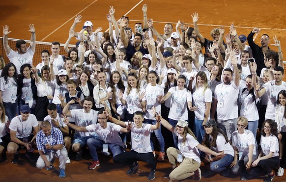 In this photo taken on Sunday, June 14, 2020, Serbia&#039;s Novak Djokovic, centre, poses with volunteers and players after the Adria Tour charity tournament in Belgrade, Serbia. Djokovic