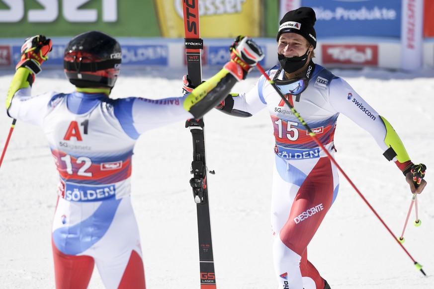 Second placed Marco Odermatt of Switzerland, right, and third placed Gino Caviezel react after the second run of the Men&#039;s Giant Slalom race of the FIS Alpine Ski World Cup season opener on the R ...