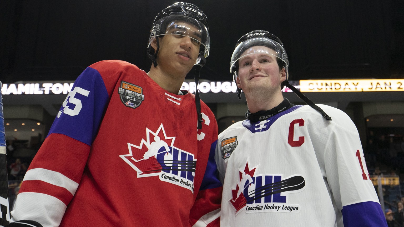 FILE - In this Jan. 16, 2020, file photo, Team Red center Quinton Byfield (55) and Team White left winger Alexis Lafreniere (11) pose for photos following hockey&#039;s CHL Top Prospects Game in Hamil ...