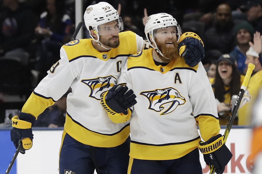 Nashville Predators&#039; Roman Josi, left, celebrates with Ryan Ellis after scoring a goal during the third period of an NHL hockey game against the New York Islanders Tuesday, Dec. 17, 2019, in Unio ...