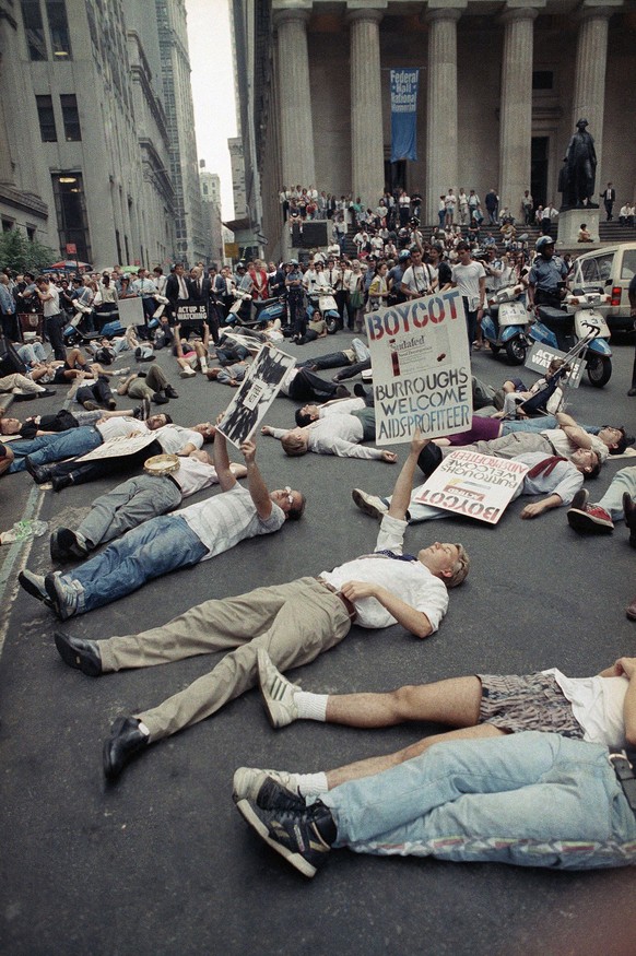 FILE - In this Thursday, Sept. 14, 1989 file photo, protestors lie on the street in front of the New York Stock Exchange in a demonstration against the high cost of the AIDS treatment drug AZT. The pr ...