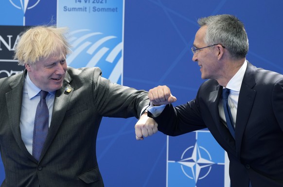 epa09269879 British Prime Minister Boris Johnson (L) is greeted by NATO Secretary General Jens Stoltenberg during a NATO summit at the North Atlantic Treaty Organization (NATO) headquarters in Brussel ...