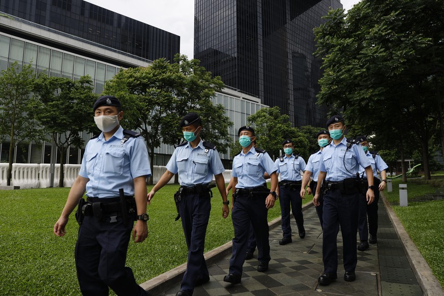 Police officers patrol outside the Central Government Offices in Hong Kong, Friday, May 22, 2020. Hong Kong&#039;s pro-democracy lawmakers have sharply criticized China&#039;s move to take over long-s ...