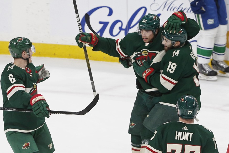 Minnesota Wild&#039;s Kevin Fiala, top left, is congratulated by teammates after his power-play goal against the Vancouver Canucks during the first period of an NHL hockey game Thursday, Feb. 6, 2020, ...