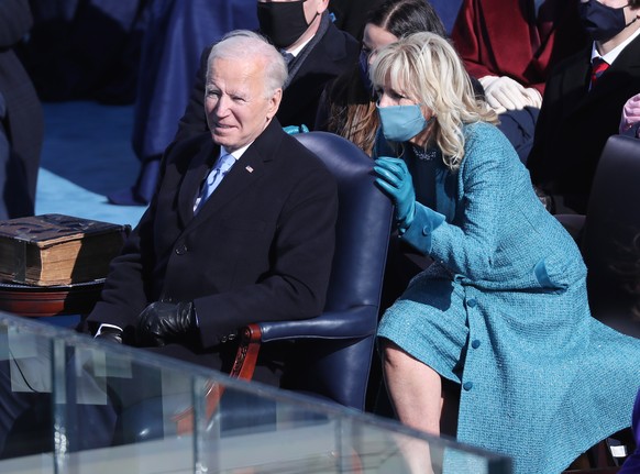 epa08953037 US President Joe Biden (L) and First Lady Dr. Jill Biden (R) as US singer Garth Brooks performs during the inaugural ceremony for President-elect Joe Biden and Vice President-elect Kamala  ...