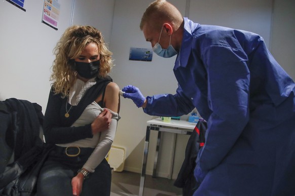 A woman receives a Pfizer COVID-19 vaccine at a new vaccination center run by the Paris&#039; fire brigade in Paris, Thursday, May 6, 2021. France joined the United States on Thursday in supporting an ...