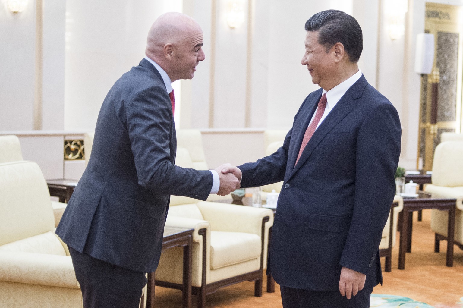 FIFA President Gianni Infantino, left, shakes hands with China&#039;s President Xi Jinping at the Great Hall of the People in Beijing on Wednesday, June 14, 2017. (Fred Dufour/Pool Photo via AP)