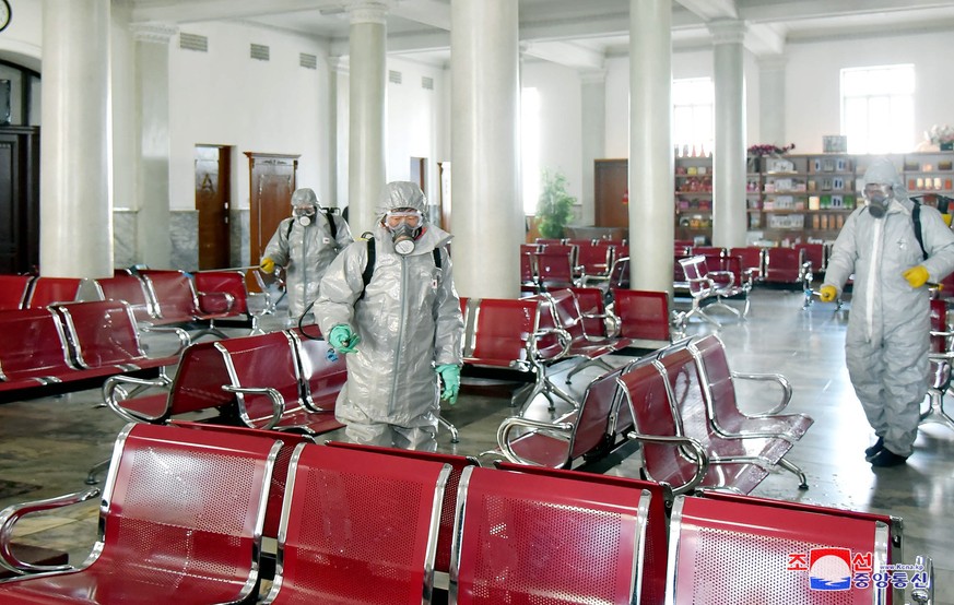 epa08218858 A photo released by the official North Korean Central News Agency (KCNA) shows people spraying disinfectant to combat the Covid-19 and coronavirus in Pyongyang, Democratic People&#039;s Re ...