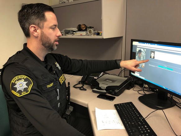 FILE - In this Feb. 22, 2019, file photo, Washington County Sheriff&#039;s Office Deputy Jeff Talbot demonstrates how his agency used facial recognition software to help solve a crime, at their headqu ...