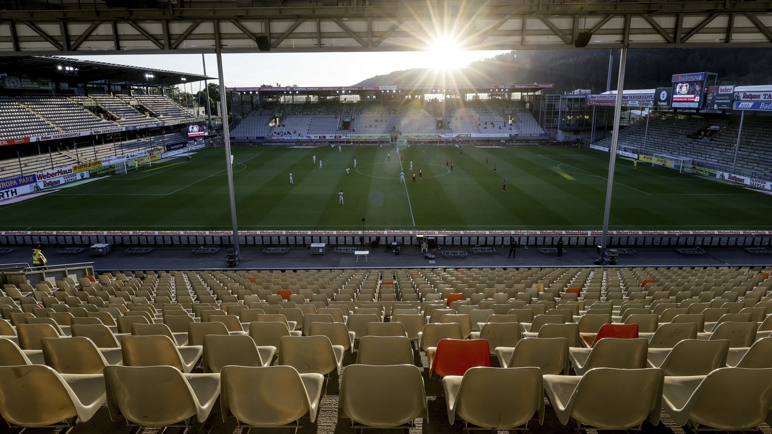 Soccer players play front of empty stands during the German Bundesliga soccer match between SC Freiburg and Bayer 04 Leverkusen in Freiburg, Germany, Friday, 29 May, 2020. Because of the coronavirus o ...