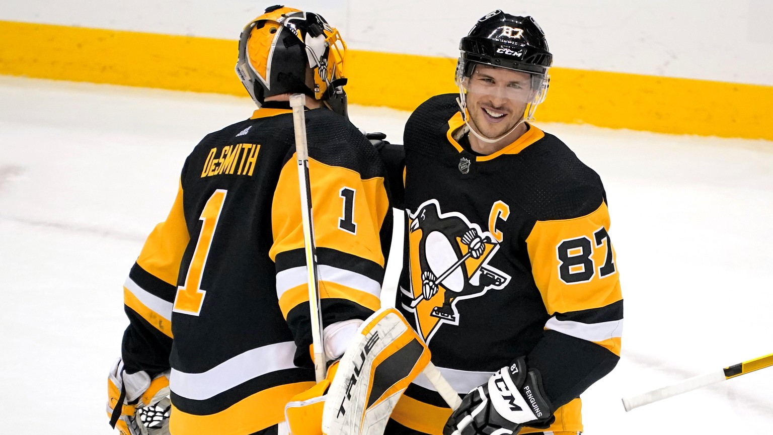 Pittsburgh Penguins&#039; Sidney Crosby (87) celebrates with goaltender Casey DeSmith after a 4-2 win over the New Jersey Devils in an NHL hockey game in Pittsburgh, Saturday, April 24, 2021. (AP Phot ...