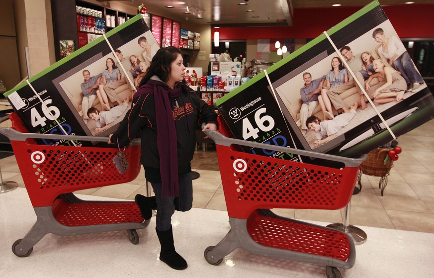 Target customer Nancy, last name not given, waits with televisions purchased at aTarget Store in Colma, Calif., Friday, Nov. 25, 2011. The American holiday shopping season began in earnest Friday as s ...