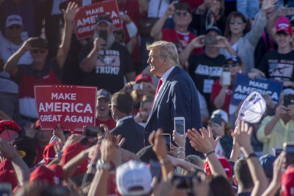 epa08782163 US President Donald J. Trump acknowledges the crowd after adressing supporters at Goodyear Airport in Phoenix, Arizona, USA, 28 October 2020. Arizona, which has been a traditionally Republ ...