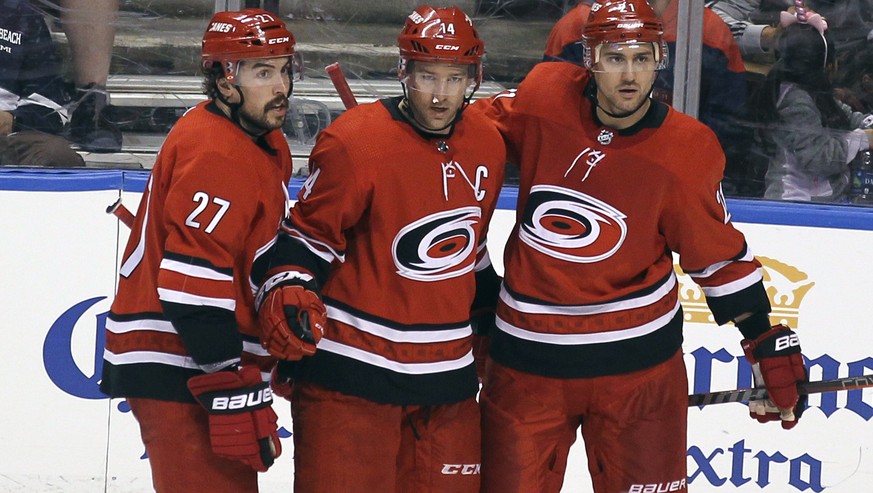 Carolina Hurricanes&#039; Justin Williams, center, celebrates with teammates Justin Faulk (27) and Nino Niederreiter, right, after scoring a goal against the Florida Panthers during the third period o ...
