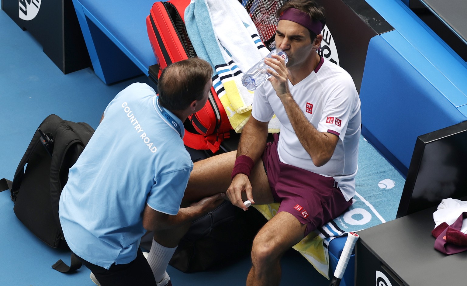 Switzerland&#039;s Roger Federer receives treatment from a trainer during his quarterfinal against Tennys Sandgren of the U.S. at the Australian Open tennis championship in Melbourne, Australia, Tuesd ...