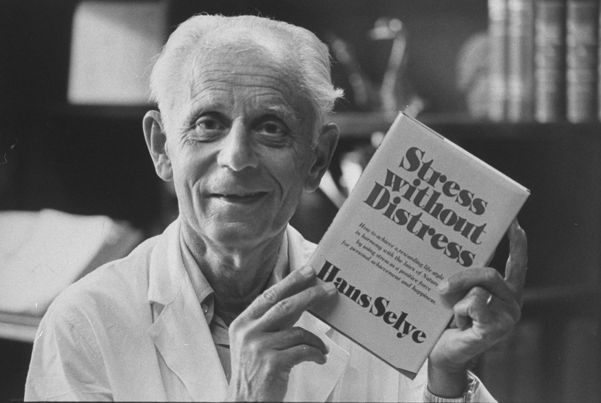 Head of Institute of Exprimmental Research and Surgery Dr. Hans Selye holding up his book Stress Without Distress. (Photo by John Olson/The LIFE Images Collection via Getty Images/Getty Images)